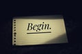 Inspirational quote - Begin. With black background of single word on white paper note concept. Life challenge simple conceptual.