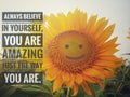 Inspirational quote - Always believe in yourself, you are amazing just the way you are. With beautiful smiling face of  sunflower Royalty Free Stock Photo