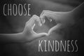 Inspirational quote - Choose kindness. With hands making love sign on black and white background. Being kind concept.