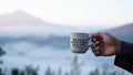 Inspirational quote - Do more of what makes your soul happy. With person holding cup of coffee on foggy mountain background. Royalty Free Stock Photo