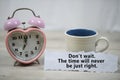 Inspirational quote - Do not wait. The time will never be just right. With alarm table clock and a cup of morning coffee.