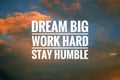 Inspirational quote - Dream big. Work hard. Stay humble. Sign and text message on dramatic colorful sky background.