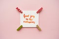 Inspirational quote find joy in the ordinary handwritten with watercolor in calligraphy style, miniature clothespins on a pale pin