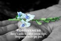 Inspirational quote - Forgiveness, does not make the other person right. Forgiveness make you free. With flower plant in hand. Royalty Free Stock Photo