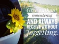 Inspirational quote - Give without remembering and always receive without forgetting. with yellow sunflower flower in bike drawer. Royalty Free Stock Photo