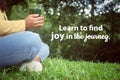 Inspirational quote - Learn to find joy in the journey. With relax legs of a woman sitting alone in the park with glass in hands. Royalty Free Stock Photo