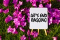 Let`s end ragging On background of pink flowers and green grass.