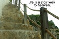 Inspirational quote - Life is a stair way to heaven. With natural wooden fence and stairs in the cliff background.