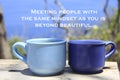 Inspirational quote - Meeting people with the same mindset as you beyond beautiful. With cups of coffee on blue outdoor backgroud.
