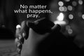 Inspirational quote - No matter what happens, pray. With prayer hands of a young girl and candle light on the table. Royalty Free Stock Photo