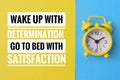 Inspirational quote with phrase WAKE UP WITH DETERMINATION GO TO BED WITH SATISFACTION Royalty Free Stock Photo