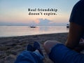 Inspirational quote - Real friendship does not expire. With two best friends of young women sitting enjoying the beach view.