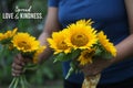 Inspirational quote - Spread love and kindness. With young woman hands holding beautiful bouquet of yellow sunflowers. Royalty Free Stock Photo