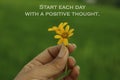 Inspirational words - Start each day with a positive thought. With two cute bautiful little daisy flowers in hand.