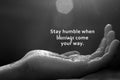 Inspirational quote - Stay humble when blessings come your way. With open arm hand receiving the light on black and white abstract