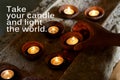 Inspirational quote - Take your candle and light the world. Motivational words with candles light on ceramic bowl. Royalty Free Stock Photo