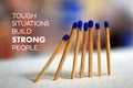 Inspirational quote - Tough situations build strong people. On background of  blue wooden matches standing as an illustration. Royalty Free Stock Photo