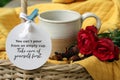 Inspirational quote - You cannot pour from an empty cup. Take care of yourself first. Text message written on tag label paper.