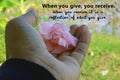 Inspirational quote - When you give, your receive. With woman holding pink flower in hand. Royalty Free Stock Photo