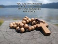 Inspirational quote - You are my favorite place to go when my mind searches for peace. With blue lake background & wooden rosary