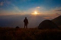 Inspirational sunrise. Man in beautiful inspiring sunrise with mountains