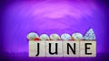 inspirational time concept - word june on wooden blocks with seashells in purple vintage background