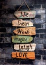 An inspirational toilet / washroom sign reading : Live, Dream, Work, Imagine, Laugh, Love.