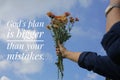 Inspirational word - God plan is bigger than your mistakes. Hand with flowers against bright and clean blue sky background.