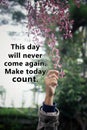 Inspirational words - This day will never come again. Make today count. Motivational quote concept with hand picking pink flower Royalty Free Stock Photo