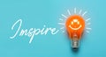 INSPIRE message with light bulb.business creativity idea Royalty Free Stock Photo