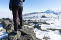 Inspire mountaineer stand over a rock contemplating the achievement of the summit. Back woman legs looking the snowy sierra on an