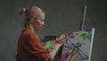 Inspired artist creating fingerpaint on canvas in art studio