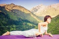 Inspired asian woman doing exercise of yoga at mountain range Royalty Free Stock Photo