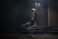 Inspired ballet dancer jumping on the dark background