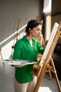 Inspired and concentrated young female student having classes at art studio Royalty Free Stock Photo