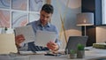 Inspired creator typing laptop in office closeup. Happy man examining renders