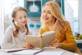 Inspired daughter reading with her mother