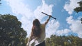 The inspired girl musician lifts the clarinet up against the blue sky.