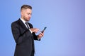 Inspired handsome businessman in formal wear standing holding sm