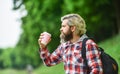 Inspired handsome hipster. Drink tea or coffee. Man with cup outdoors. Man outdoors with cup of coffee. Drinking hot Royalty Free Stock Photo