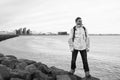 Inspired man on sea beach in reykjavik, iceland. Man traveler smile and looking in future on sea shore. freedom sence Royalty Free Stock Photo