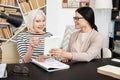 Inspired mature woman reading in Chinese