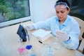 Multi-ethnic woman, pharmacologist in white lab coat, working on development of new medical drug in research laboratory Royalty Free Stock Photo