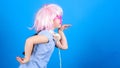 Inspired by music. Little kid listening music. Cute kid with headphones blue background. Small girl headphones pink wig Royalty Free Stock Photo