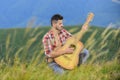 Inspired musician play rock ballad. Compose melody. Inspiring environment. Man with guitar on top of mountain. Acoustic Royalty Free Stock Photo