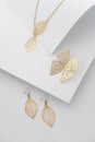 Inspired by nature jewelry set - Leaves shape earrings and necklace with butterfly shape earrings on white folded paper