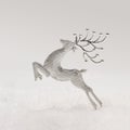 Inspired new year journeying. Beautiful silver ornament reindeer against gray background
