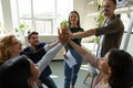 Inspired office employees giving group high five Royalty Free Stock Photo