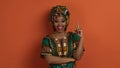 Inspired pretty black woman in african costume showing eureka gesture Royalty Free Stock Photo