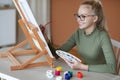Inspired teen girl holding brush and palette, painting